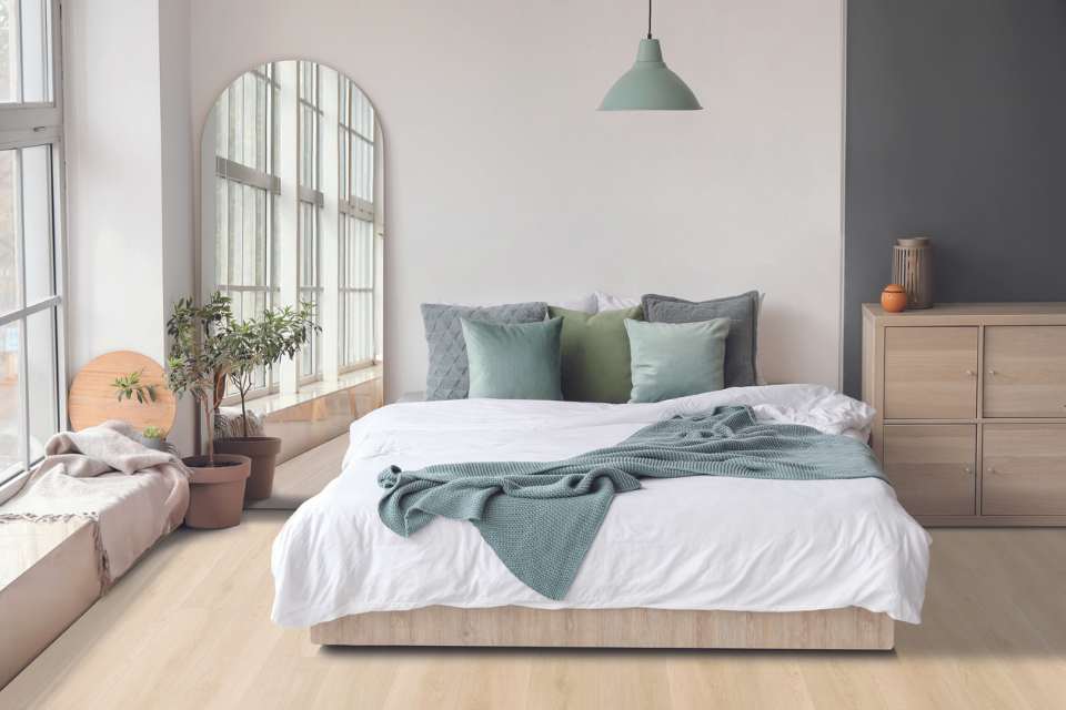 serene color palette in modern minimal bedroom with light oak wood floors and arched mirror